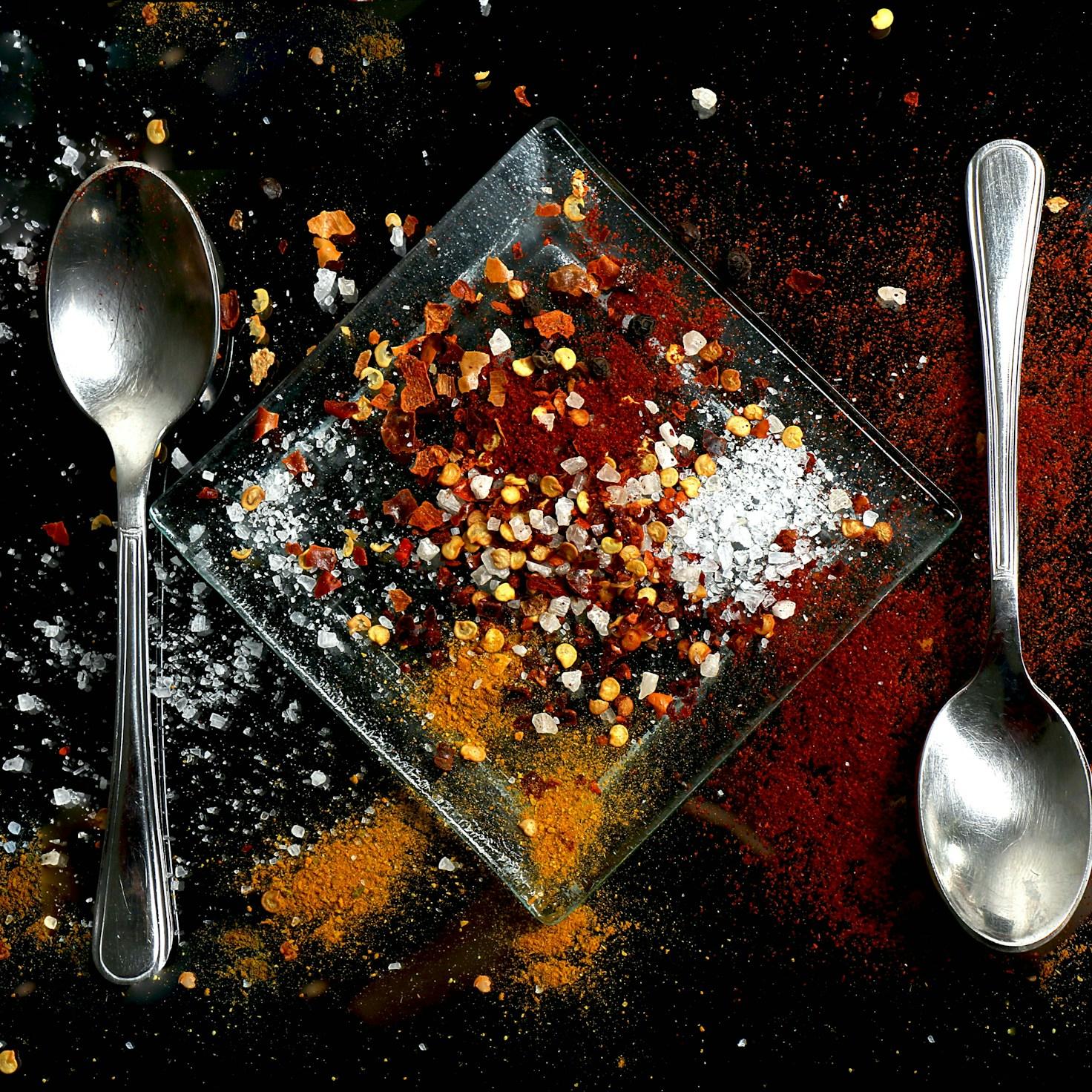 Community members collaborating in a contemporary kitchen, exchanging recipes and techniques